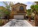 Charming two-story home with a two car garage and desert landscaping at 6279 Dollar Bill Ct, Las Vegas, NV 89141