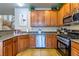 Kitchen with granite counters, stainless appliances, and wood cabinets at 6279 Dollar Bill Ct, Las Vegas, NV 89141