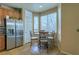 Kitchen nook with a stainless steel refrigerator and a dining table at 6279 Dollar Bill Ct, Las Vegas, NV 89141