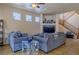 Comfortable living room featuring tile floors, staircase, and a ceiling fan at 6279 Dollar Bill Ct, Las Vegas, NV 89141