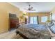 Spacious main bedroom with ceiling fan, en suite bathroom access, sliding door access to a balcony, and neutral wall color at 6279 Dollar Bill Ct, Las Vegas, NV 89141