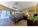 Bright and airy main bedroom with ceiling fan, a sliding glass door to a balcony, carpeted floor, and neutral color scheme at 6279 Dollar Bill Ct, Las Vegas, NV 89141