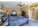 Spacious main bedroom with en suite bathroom, ceiling fan, carpet floor, natural light, and neutral wall color at 6279 Dollar Bill Ct, Las Vegas, NV 89141
