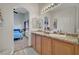 Bright and airy bathroom with granite double vanity and arched doorway at 6433 Buck Jones Ave # 102, Las Vegas, NV 89122