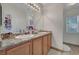 Bathroom features a granite double vanity, framed mirror, and ample counter space at 6433 Buck Jones Ave # 102, Las Vegas, NV 89122