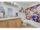 Bathroom featuring cultured marble vanity with light wood cabinets and shower with fun character curtain at 6433 Buck Jones Ave # 102, Las Vegas, NV 89122