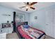 Bedroom featuring blue walls, neutral carpet, a ceiling fan and a window with blinds and a side curtain at 6433 Buck Jones Ave # 102, Las Vegas, NV 89122