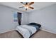 Bedroom featuring neutral carpet, ceiling fan, and window with blinds and a side curtain at 6433 Buck Jones Ave # 102, Las Vegas, NV 89122