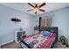 Bedroom featuring blue walls, neutral carpet, a ceiling fan and a window with blinds and a side curtain at 6433 Buck Jones Ave # 102, Las Vegas, NV 89122