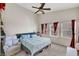 Spacious bedroom featuring a ceiling fan, large windows, and comfortable furnishings at 6433 Buck Jones Ave # 102, Las Vegas, NV 89122