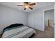 Bedroom featuring neutral carpet, ceiling fan, and window with blinds and a side curtain at 6433 Buck Jones Ave # 102, Las Vegas, NV 89122