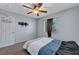 Bedroom featuring neutral carpet, ceiling fan, and window with blinds and a side curtain at 6433 Buck Jones Ave # 102, Las Vegas, NV 89122