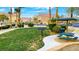 Inviting common area featuring a picnic table, grill, lush green grass, and well-maintained landscaping at 6433 Buck Jones Ave # 102, Las Vegas, NV 89122