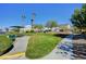 Community space featuring picnic spots, green lawns, mature trees, and beautifully maintained landscaping at 6433 Buck Jones Ave # 102, Las Vegas, NV 89122