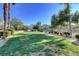Expansive green space within the community, featuring seating, manicured landscaping, and walking paths at 6433 Buck Jones Ave # 102, Las Vegas, NV 89122