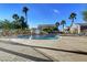 Inviting community pool area featuring lounge chairs, palm trees, and clear blue water for relaxation at 6433 Buck Jones Ave # 102, Las Vegas, NV 89122