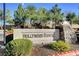Elegant community sign with stone accents, surrounded by manicured landscaping and mature trees at 6433 Buck Jones Ave # 102, Las Vegas, NV 89122