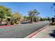 Street view of the gated entrance to the community, surrounded by mature trees and landscaping at 6433 Buck Jones Ave # 102, Las Vegas, NV 89122