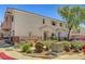 Pleasant exterior view of townhomes with neat landscaping and neutral color palette at 6433 Buck Jones Ave # 102, Las Vegas, NV 89122