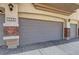 Attached two-car garage with brick accents on either side and an automatic door at 6433 Buck Jones Ave # 102, Las Vegas, NV 89122