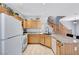 Charming kitchen with wooden cabinets, granite countertops, and tile floors, conveniently located near the stairs at 6433 Buck Jones Ave # 102, Las Vegas, NV 89122