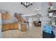 Open-concept kitchen with wood cabinets, granite countertops, and tile floors leading to the living room at 6433 Buck Jones Ave # 102, Las Vegas, NV 89122
