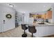 Bright kitchen with granite countertops, stainless steel sink, and breakfast bar seating two at 6433 Buck Jones Ave # 102, Las Vegas, NV 89122