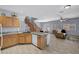 Open kitchen with wooden cabinets, granite countertops, and seamless flow into the living area at 6433 Buck Jones Ave # 102, Las Vegas, NV 89122