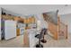 Well-equipped kitchen with a breakfast bar, white appliances, and a staircase nearby at 6433 Buck Jones Ave # 102, Las Vegas, NV 89122