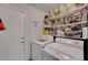 Organized laundry room with shelving, washer, and dryer hookups at 6433 Buck Jones Ave # 102, Las Vegas, NV 89122