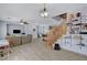 Bright and spacious living room with an open layout, stairs, and an adjoining kitchen at 6433 Buck Jones Ave # 102, Las Vegas, NV 89122