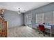 Contemporary living area with a sliding glass door, modern desk and bright window at 6433 Buck Jones Ave # 102, Las Vegas, NV 89122