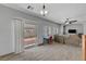 Inviting living room features wood-look tile floors, neutral paint, and sliding glass doors to the backyard at 6433 Buck Jones Ave # 102, Las Vegas, NV 89122