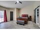 Bright bedroom with ensuite bathroom access, a ceiling fan, and an exterior door at 6517 W Brooks Ave, Las Vegas, NV 89108
