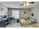 Comfortable bedroom featuring a desk, ceiling fan, and window at 6517 W Brooks Ave, Las Vegas, NV 89108