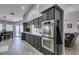 Charming kitchen with gray cabinets, white countertops, stainless steel appliances, and wood-look tile flooring at 6517 W Brooks Ave, Las Vegas, NV 89108