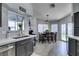 Bright eat-in kitchen with gray cabinets, stainless steel dishwasher, and backyard views at 6517 W Brooks Ave, Las Vegas, NV 89108