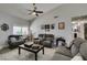 Comfortable living room with plush seating, a ceiling fan, and a bright window at 6517 W Brooks Ave, Las Vegas, NV 89108