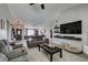 Spacious living room featuring an open floor plan, neutral decor, and modern lighting at 6517 W Brooks Ave, Las Vegas, NV 89108