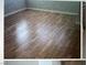 A room with hardwood floors needing some repairs at 6531 Goldfield St, North Las Vegas, NV 89084