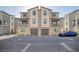 Modern townhome exterior with balconies and attached two-car garage, showcasing contemporary design at 7003 Crimson Shadow St, North Las Vegas, NV 89086