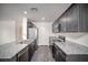 Well-equipped kitchen with granite countertops, stainless steel appliances, and dark wood cabinetry at 7003 Crimson Shadow St, North Las Vegas, NV 89086