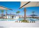 Resort-style pool with palm trees, lounge chairs, and shade structures on a sunny day at 7003 Crimson Shadow St, North Las Vegas, NV 89086