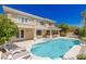 Resort-style backyard featuring a pool, outdoor kitchen, lounge seating, and a meticulously maintained landscape at 712 Proud Eagle Ln, Las Vegas, NV 89144