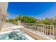 Outdoor balcony with a table and chairs, perfect for relaxing and enjoying the views of the mature trees at 712 Proud Eagle Ln, Las Vegas, NV 89144