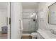 Bright bathroom featuring a glass shower with decorative tiling and modern fixtures at 712 Proud Eagle Ln, Las Vegas, NV 89144
