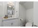 Stylish half bath with white vanity, modern mirror, and fixtures at 712 Proud Eagle Ln, Las Vegas, NV 89144