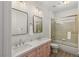 Double sink bathroom with marble countertop and glass shower/tub combination at 712 Proud Eagle Ln, Las Vegas, NV 89144