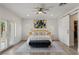 Spacious main bedroom featuring a ceiling fan, ensuite bathroom, and access to a private patio at 712 Proud Eagle Ln, Las Vegas, NV 89144