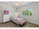 Bright bedroom with a twin bed, shuttered windows, and a pink-themed decor at 712 Proud Eagle Ln, Las Vegas, NV 89144